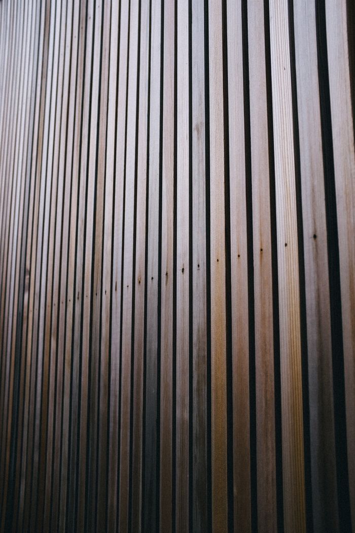 Close-up of vertical wooden wall panels showcasing natural wood texture and grain.