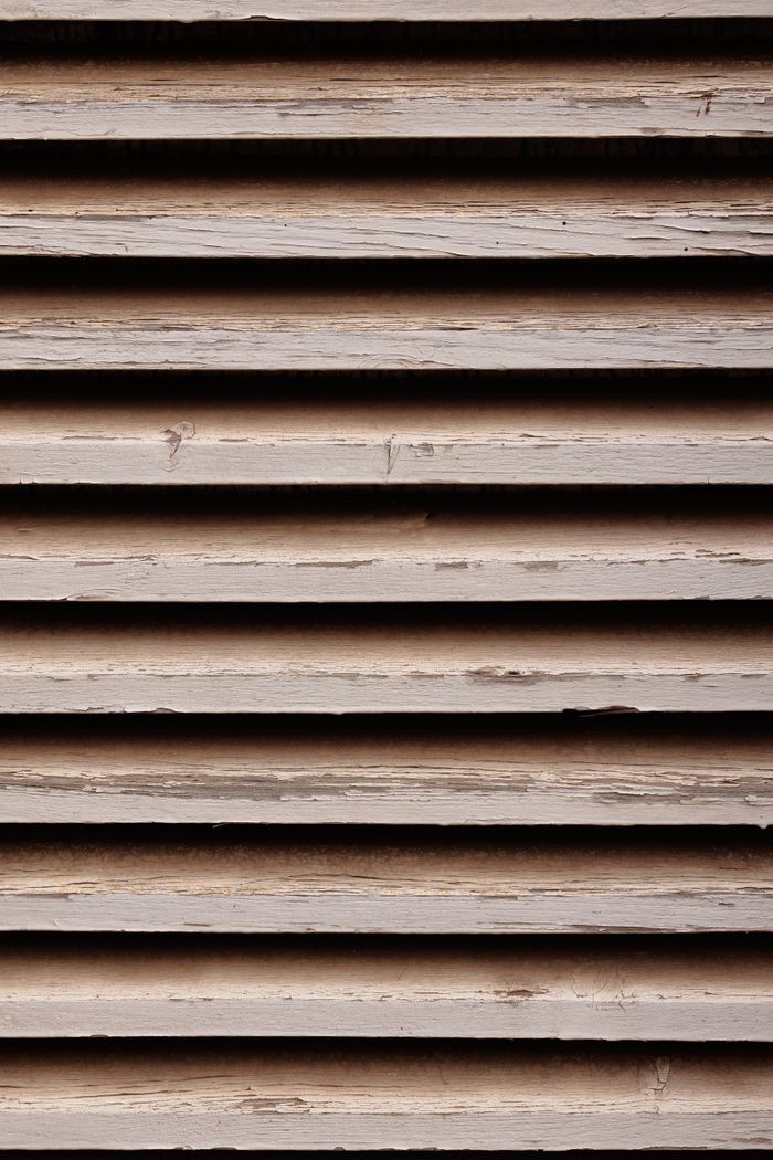 Close-up of aged wooden shutters showcasing a rustic, weathered texture.